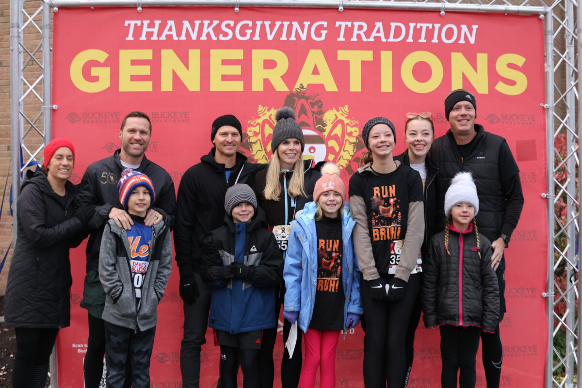 Multiple generations of a family at the Turkey Chase Generations Wall in downtown Toledo.