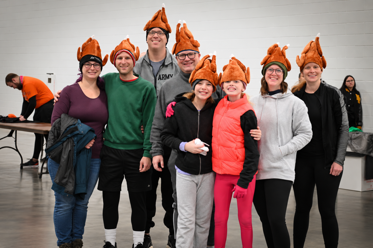 Family and friends wearing turkey hats gather at Dave’s Turkey Chase, a Thanksgiving Day race in Toledo, Ohio.
