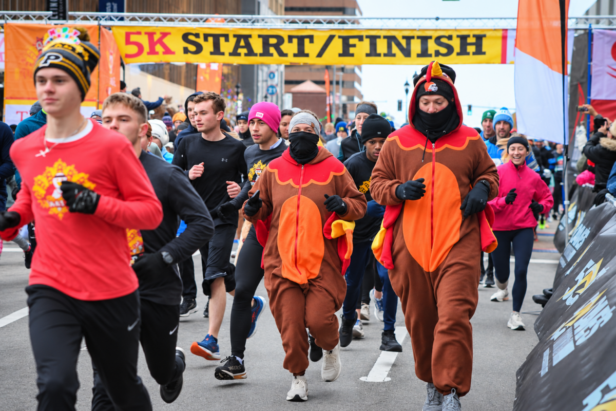 Runners in turkey costumes join the Dave’s Turkey Chase 5K start in downtown Toledo on Thanksgiving morning.