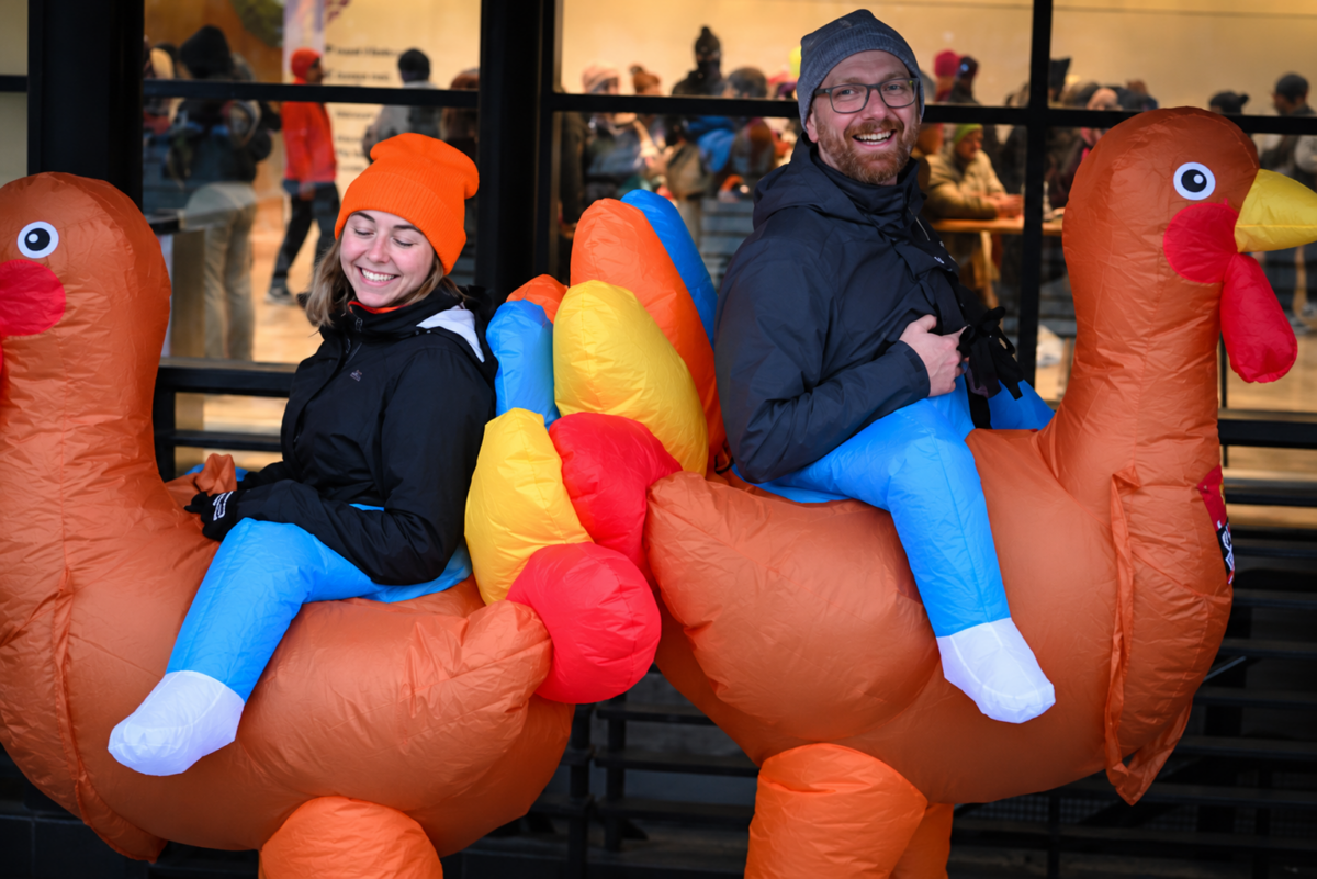 Two participants dressed in inflatable turkey costumes celebrate Dave’s Turkey Chase, a Thanksgiving Day running tradition in downtown Toledo, Ohio.